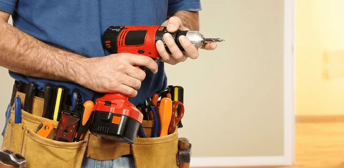 Handyman holding a power drill for home repairs and installations in Hialeah, FL